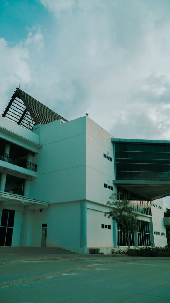 A contemporary building featuring solar panels under a cloudy sky, highlighting modern architecture.